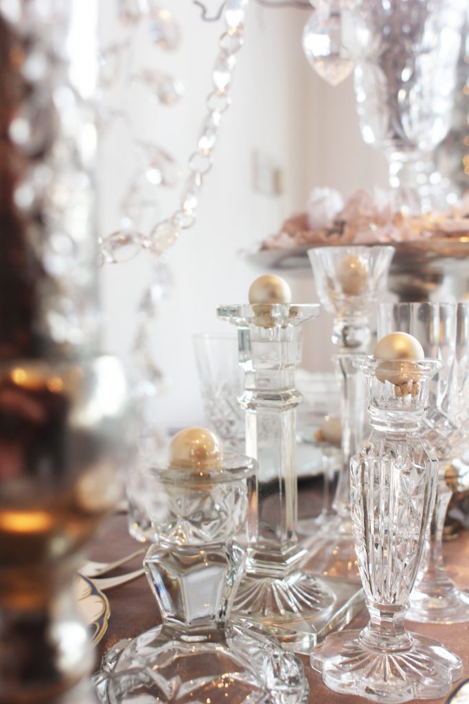 mixed glass candlesticks and vintage vases with cut crystal hangings and pearl baubles to hire for weddings in the Cotswolds