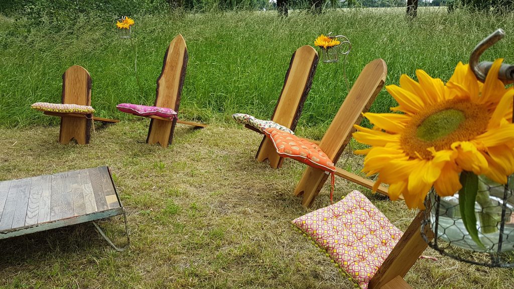 In a clearing in the middle of the woods we set up a circle of wooden Viking chairs with funky multicoloured cushions on each on