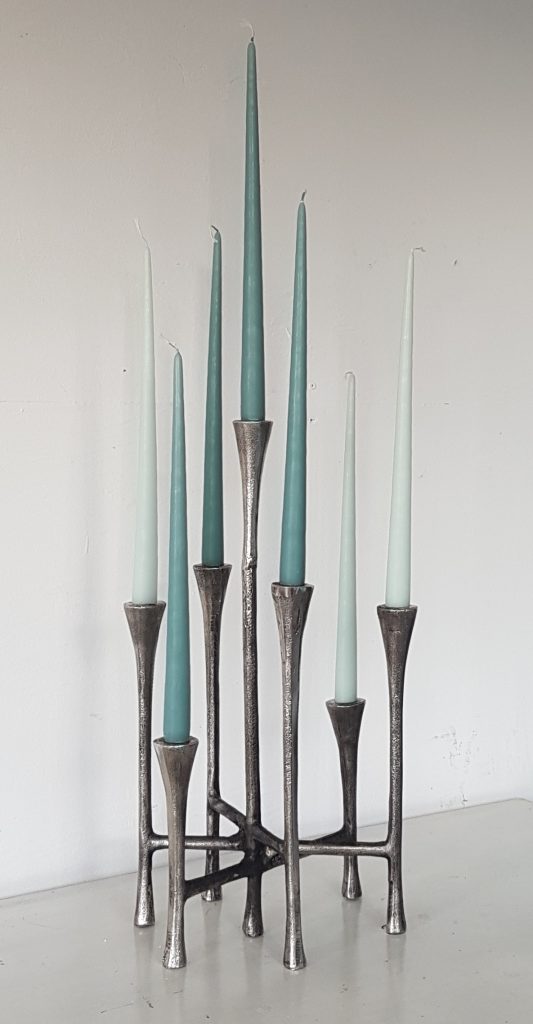 Seven stick candelabra with each spoke at a different height in silver with blue and white candlesticks for hire