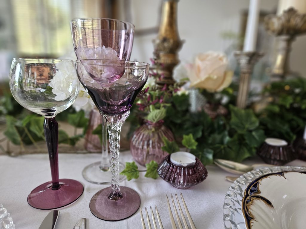 Twisted stem vintage small wine glass with a purple tint next to a purple stem wine glass and a small purple tealight holder for hire