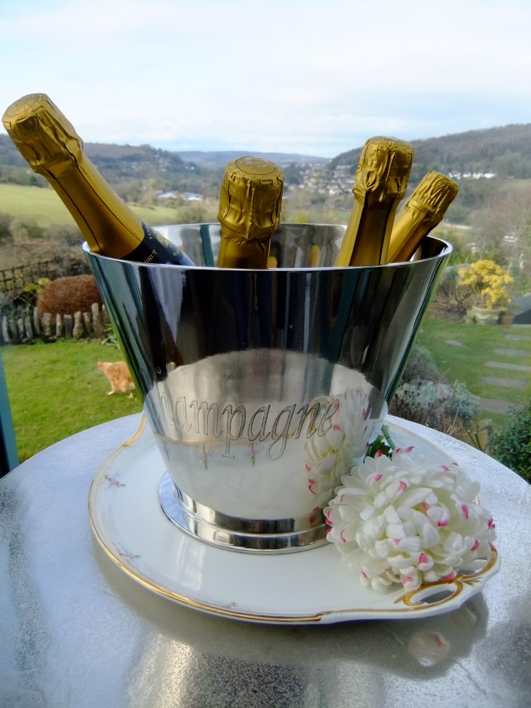silver large high shine champagne or prosecco ice bucket with gold top champagne in it for hire