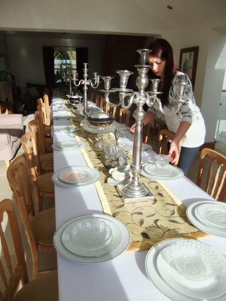 A member of our team setting up a Downton abbey inspired dinner party available to hire