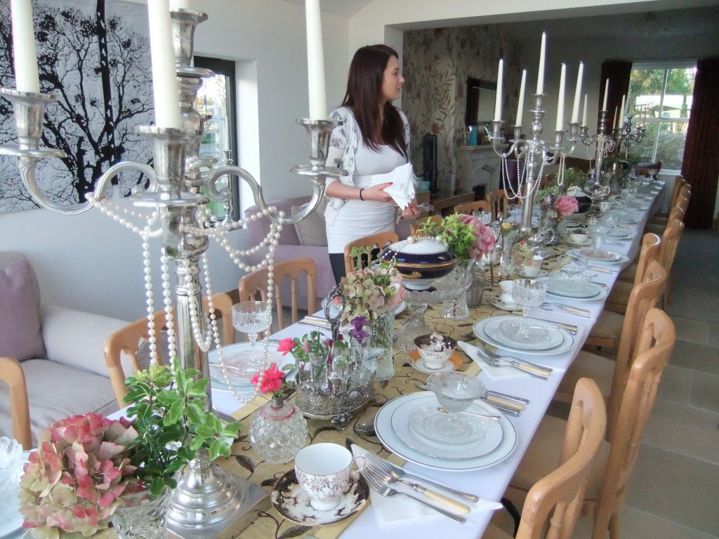 A member of our team setting up a Downton abbey inspired dinner party available to hire