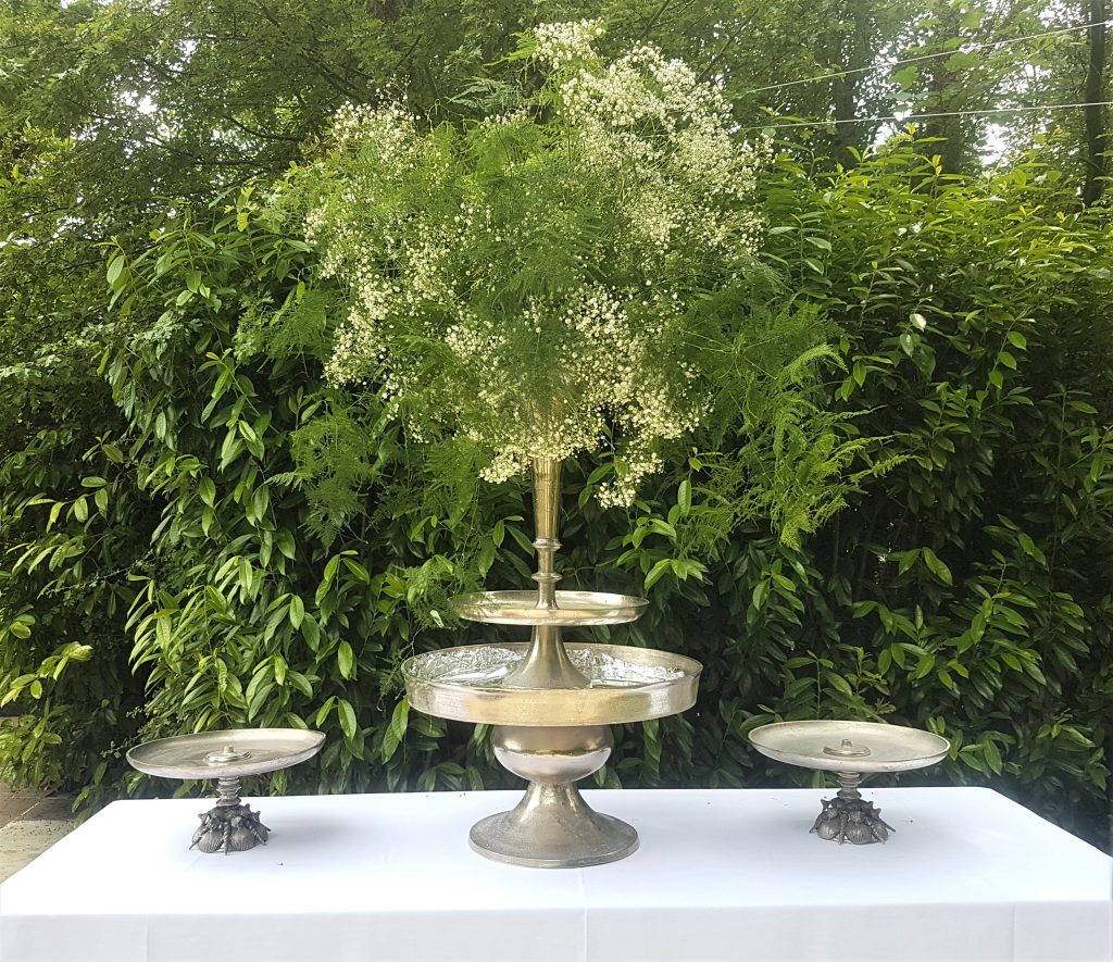 Stunning large silver trumpet vase filled with ferns and gypsophila for hire
