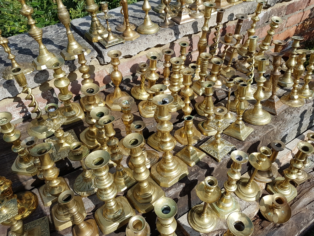 Huge collection of vintage brass candlesticks available to hire