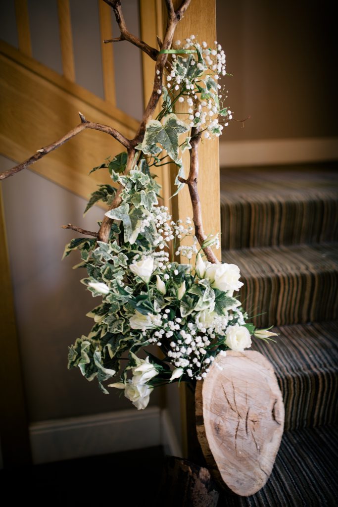 White and green ivy wrapped around twigs for a winter woodland wedding at hyde barn and hyde house available to hire