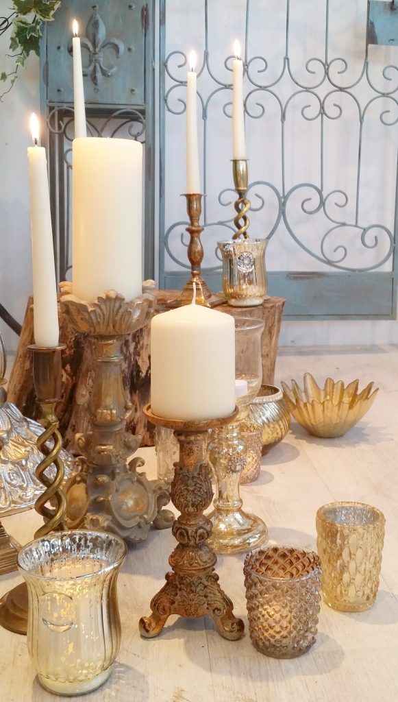 A variety of brass and gold candlestick holders and tealight holders to hire