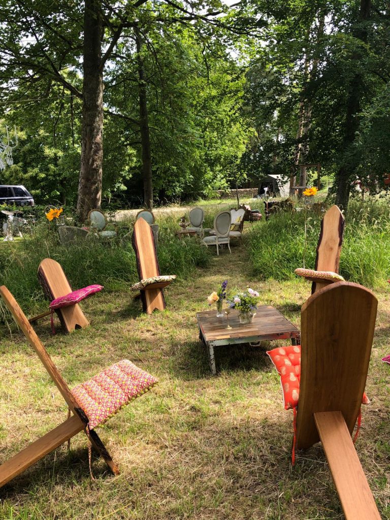 In a clearing in the middle of the woods we set up a circle of wooden Viking chairs with funky multicoloured cushions on each on