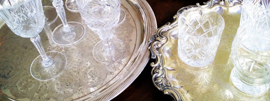 Cut crystal vintage wine glasses, water tumblers and champagne saucers, on ornate vintage silver trays to hire