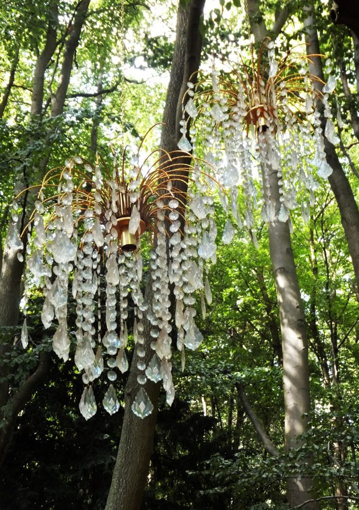 chandelier style lamp shades in trees, Crystal and beads for reflecting light at a woodland wedding for hire