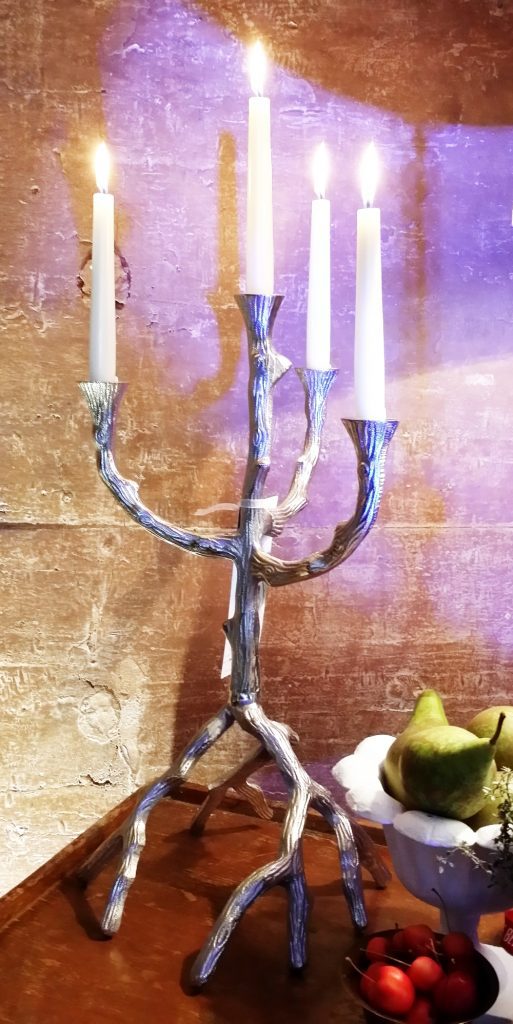 Twig style unusual silver candelabra against a Cotswold stone wall available to hire