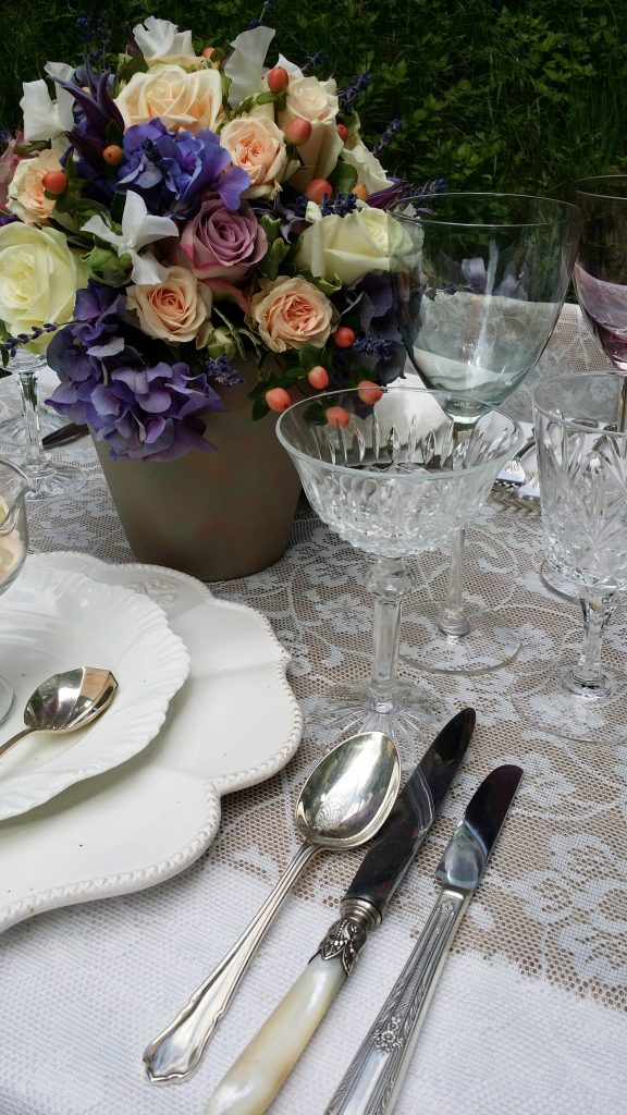 Vintage silver cutlery and glass sundae bowl with cut crystal champagne saucer to the right hand side to hire