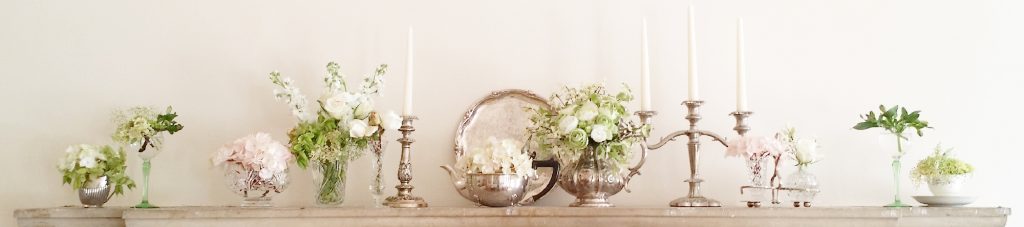 vintage silver candlesticks and glass vases for mantlepiece decoration