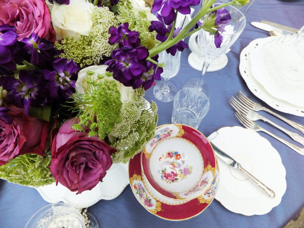 Close up of a vintage tea set  and cutlery and cut crystal wine glass, water glass and champagne flute