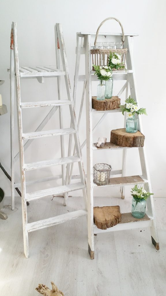 rustic white wooden step ladders with tree stumps and tealights and recycled glass jars available to hire for weddings and events
