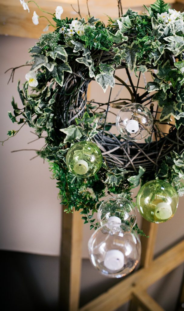 woodland wedding wreaths with fake greenery and hanging glass bauble tea lights available to hire