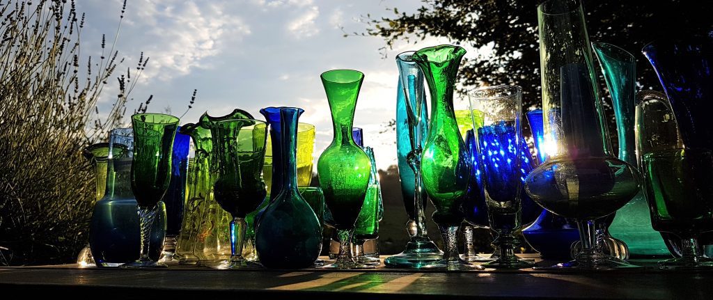 Blue and green glass vases, some bud vases and some brandy style vases